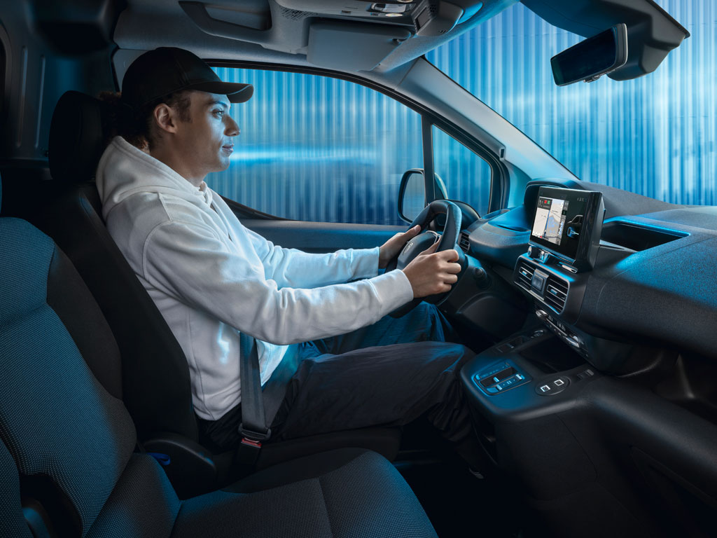Man driving the new PEUGEOT E-PARTNER