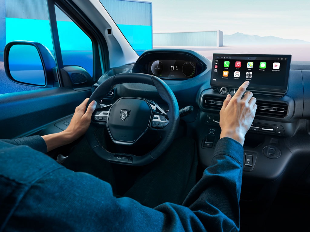 Man on board new PEUGEOT E-PARTNER using touchscreen