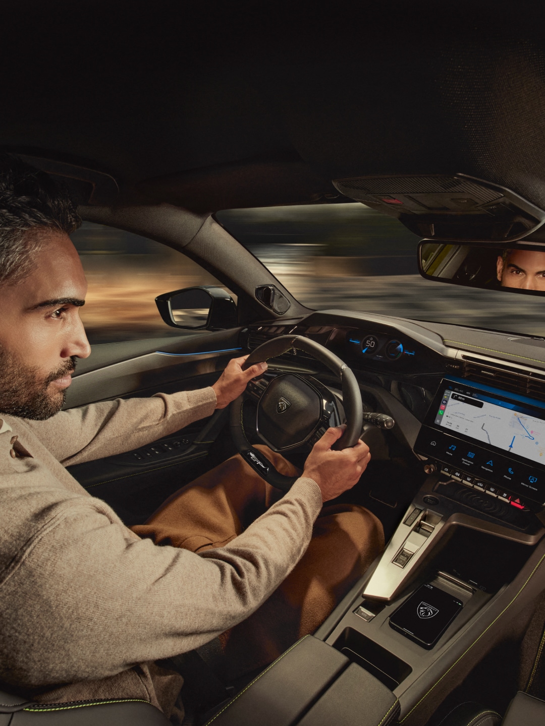 A man driving a Peugeot
